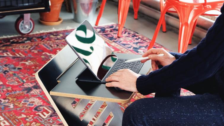 Picture of person writing on Laptop